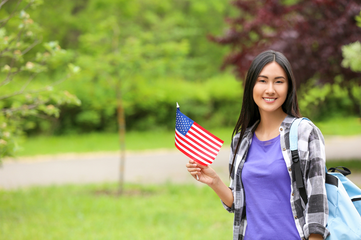 Asian Student with USA Flag Outdoors
